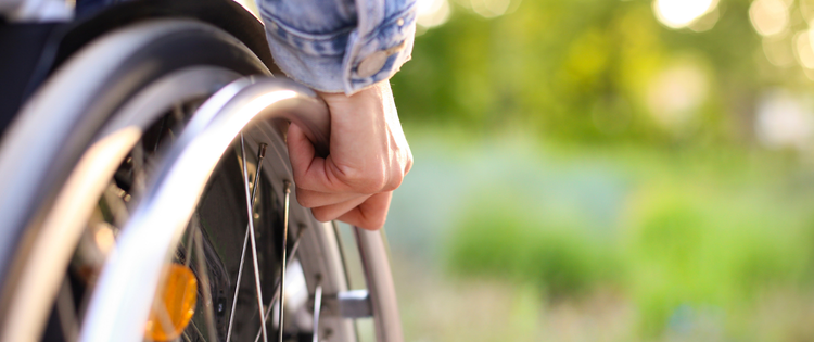 Hand holding a wheelchair.